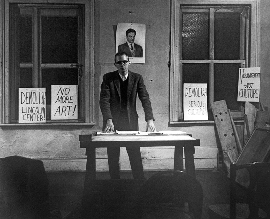 Diane Wakoski, Henry Flynt delivering the lecture ‘From Culture to Veramusement’ in Walter De Maria’s loft, 28 February 1963, b/w photo, 36 × 30 cm. Courtesy Henry Flynt