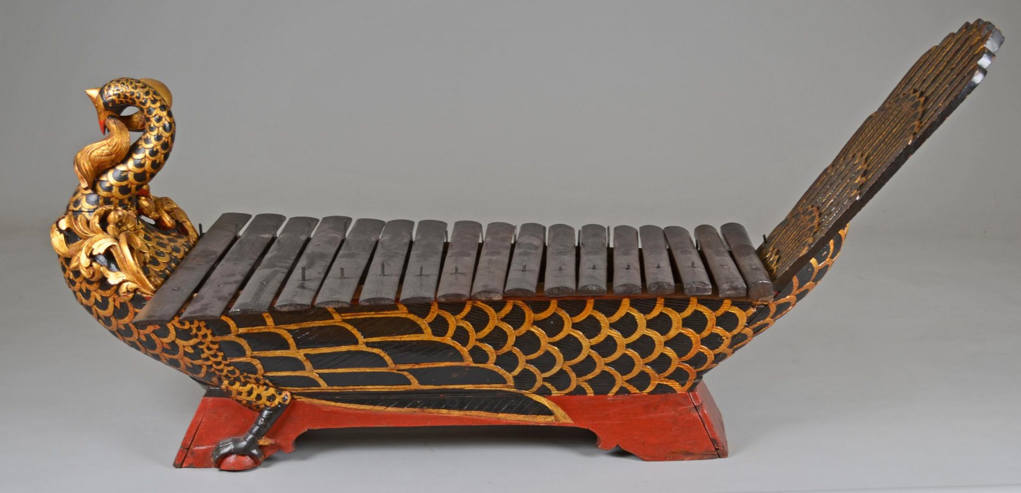 Gamelan instrument in the shape of a peacock, 'gambang kayu' made of lacquered wood (red, black and gold). With 17 wooden keys © The Trustees of the British Museum