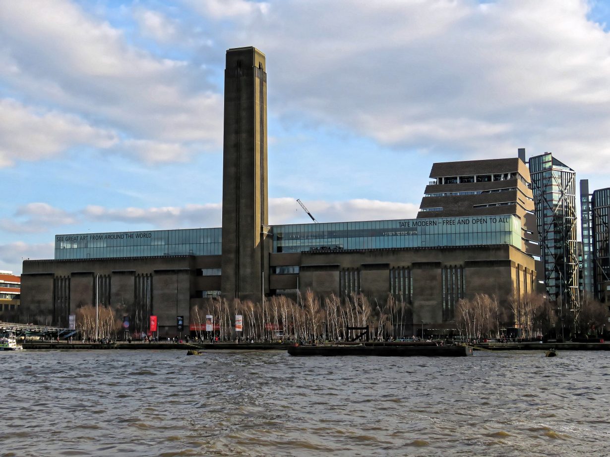 A side view of Tate Modern seen from the other side of the river bank