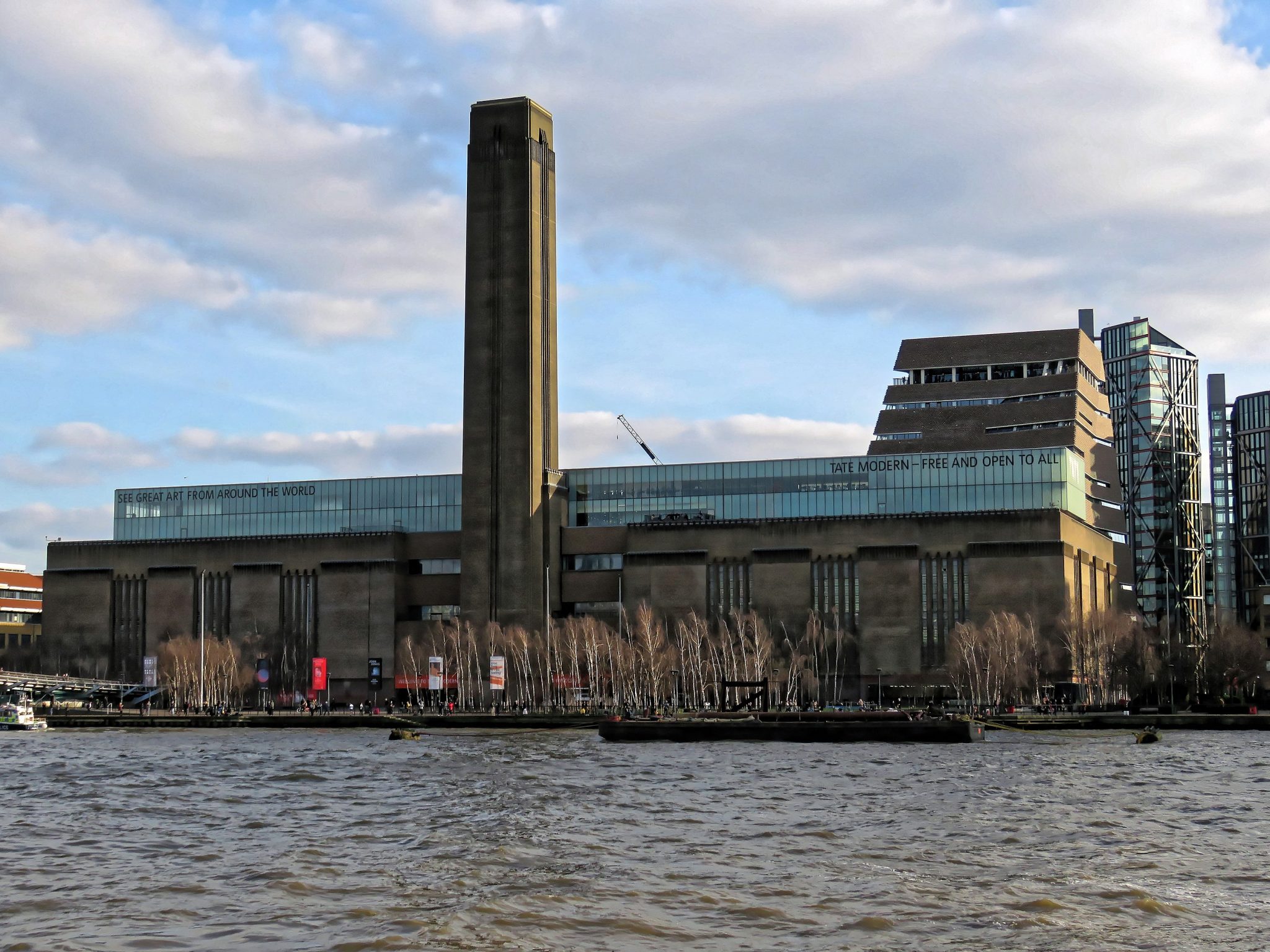 A side view of Tate Modern seen from the other side of the river bank