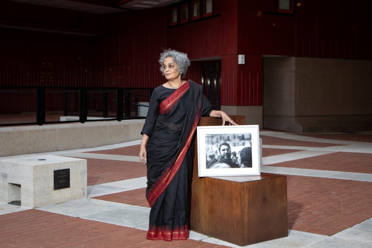 Arundhati Roy, PEN Pinter Prize 2024 winner, with a photograph of Alaa Abd el-Fattah, named Writer of Courage by Roy. Courtesy PEN. Photo: George Torode