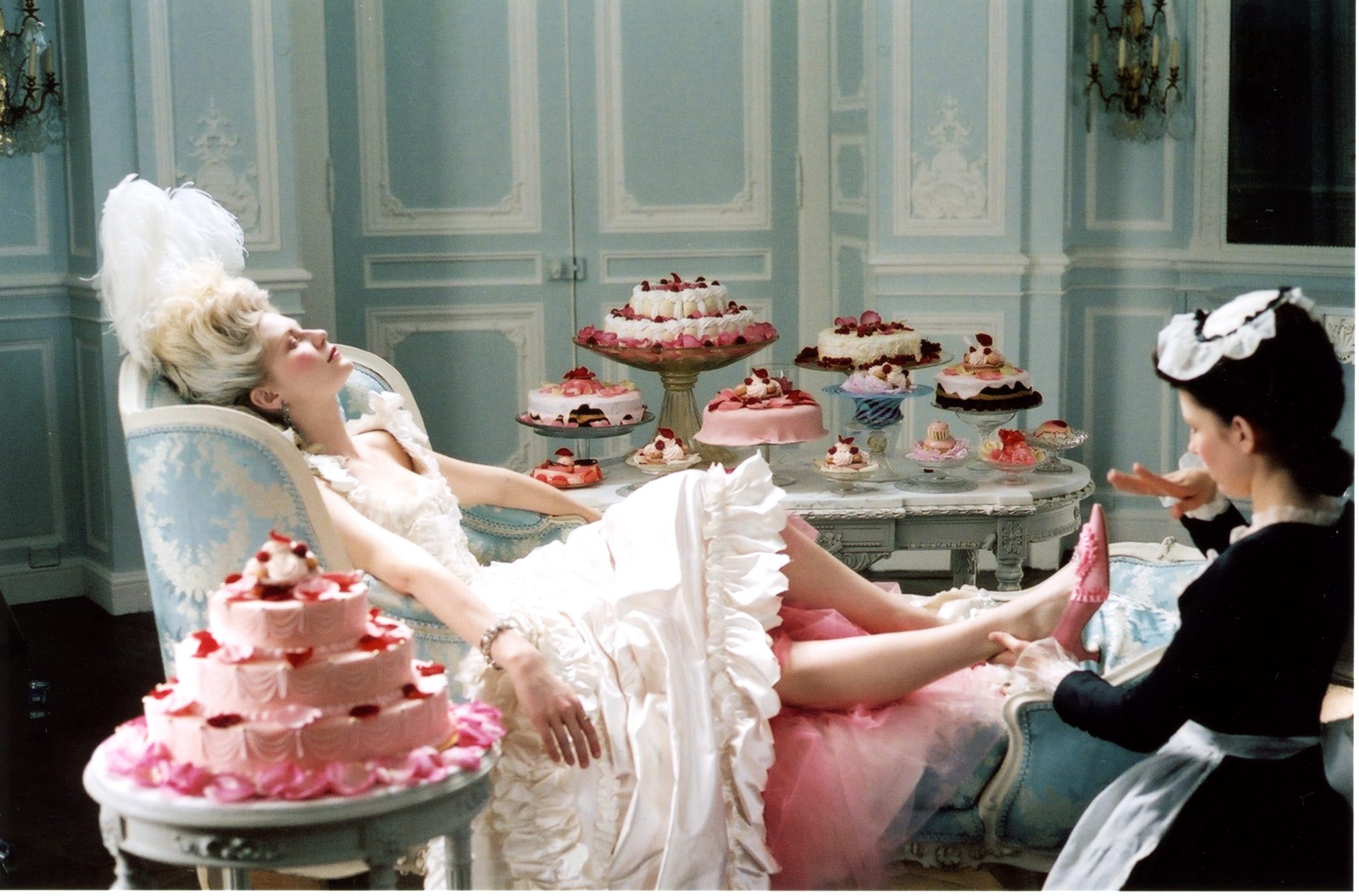 Film still showing Marie Antoinette surrounded by cakes