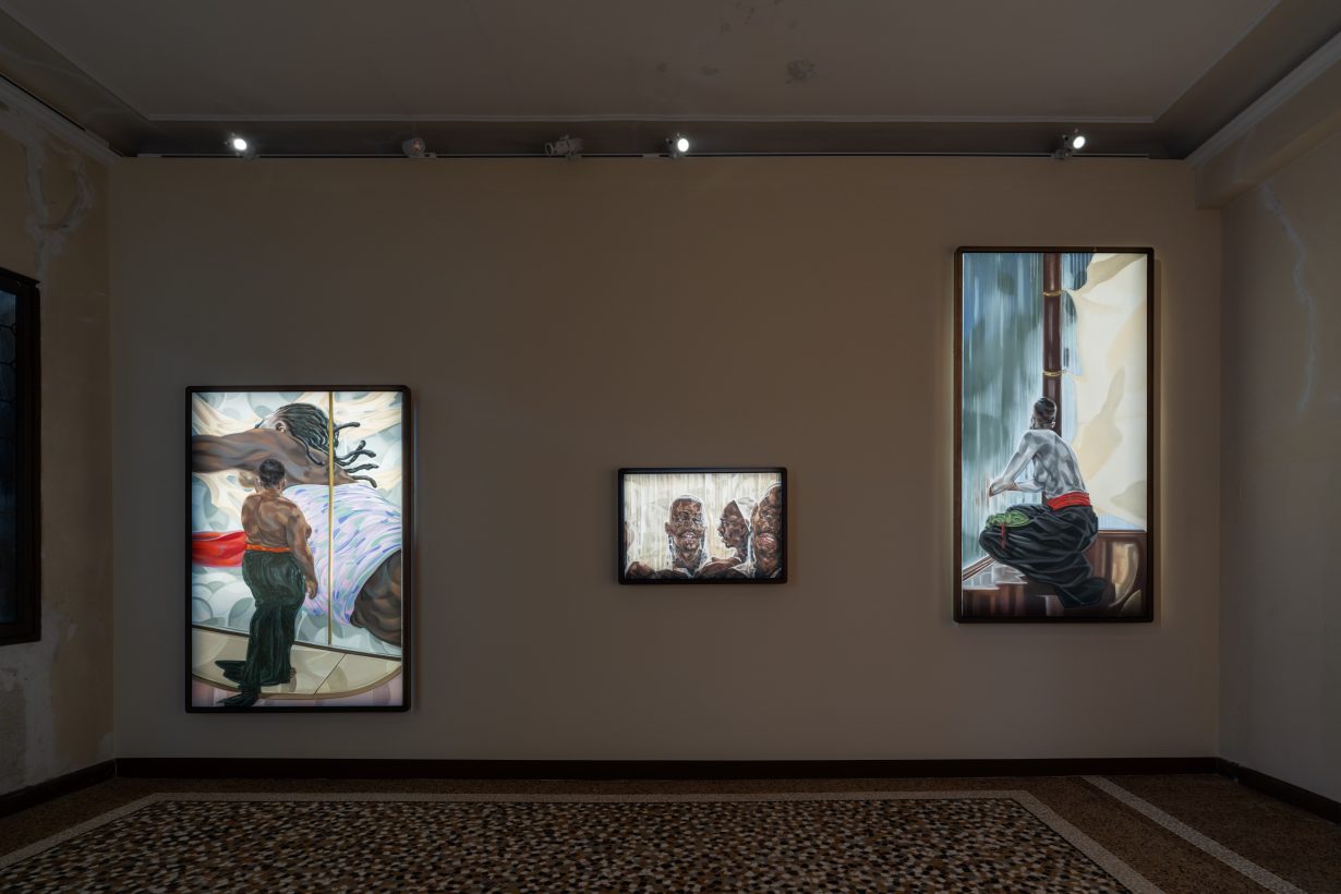 Installation shot of three paitings featuring black figures