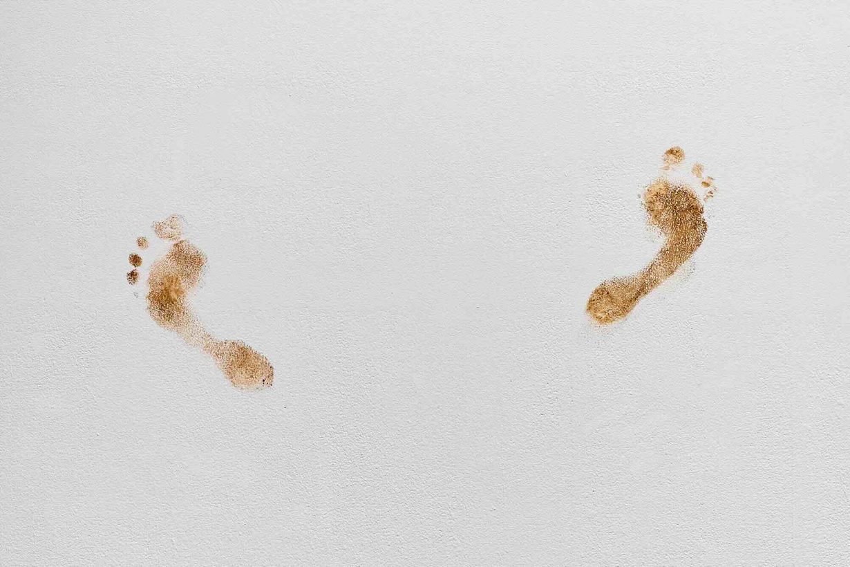 Two footprints on a white floor