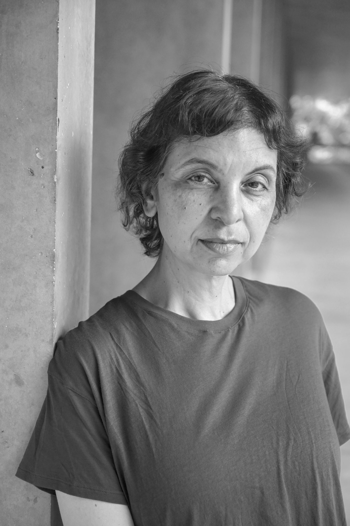 A black and white portrait of a woman wearing a t-shirt