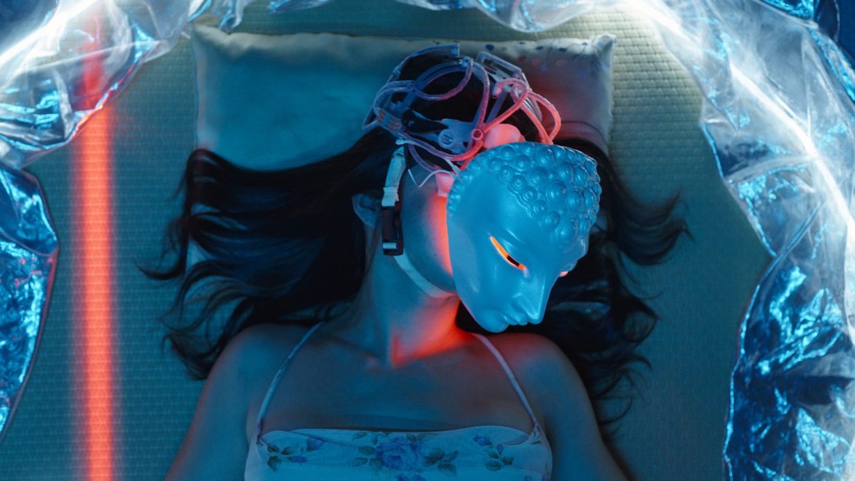 An image of a person with long hair and a light-up mask