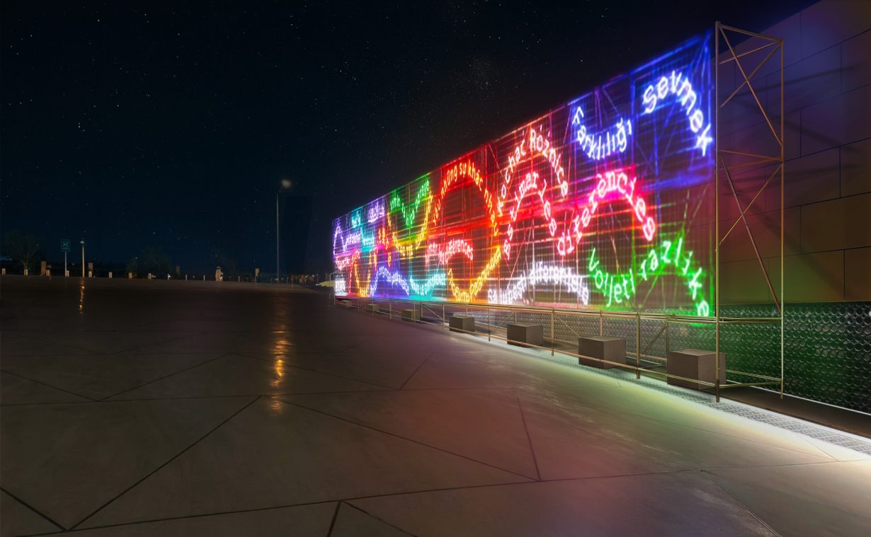 A dark street with a neon textual multicoloured artwork