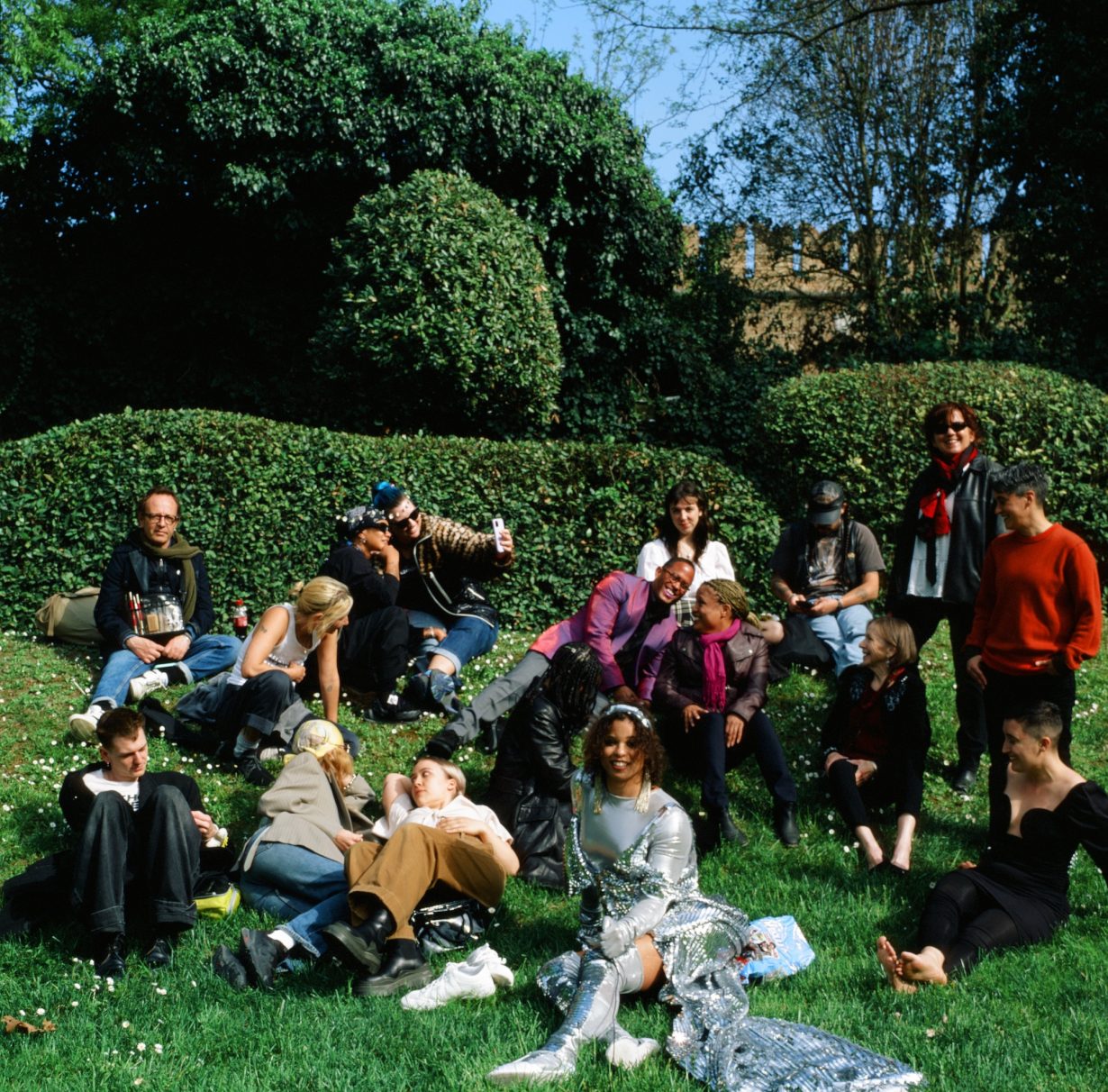 Several people standing outside on a sunny day