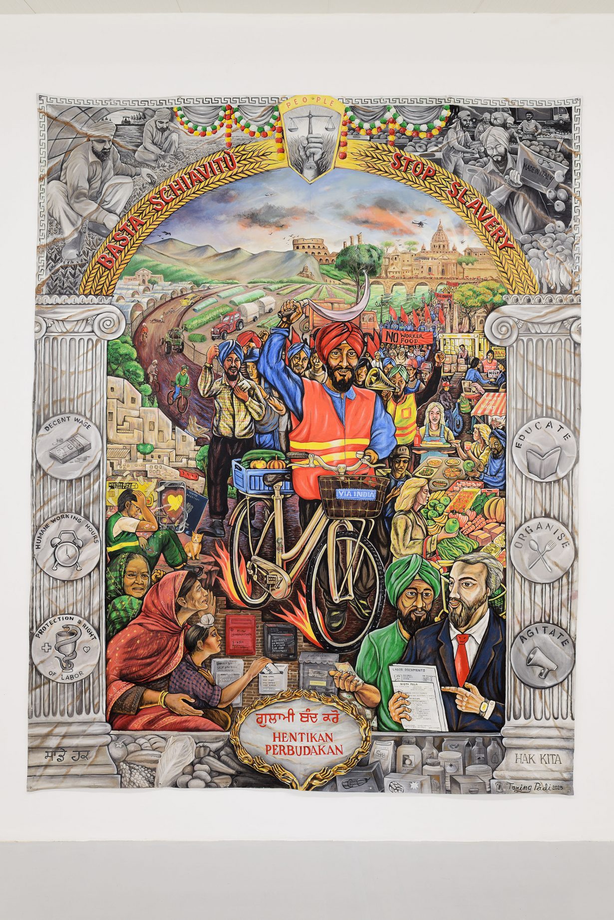 An artwork with a man on a bike surrounded by people and the words 'stop slavery'