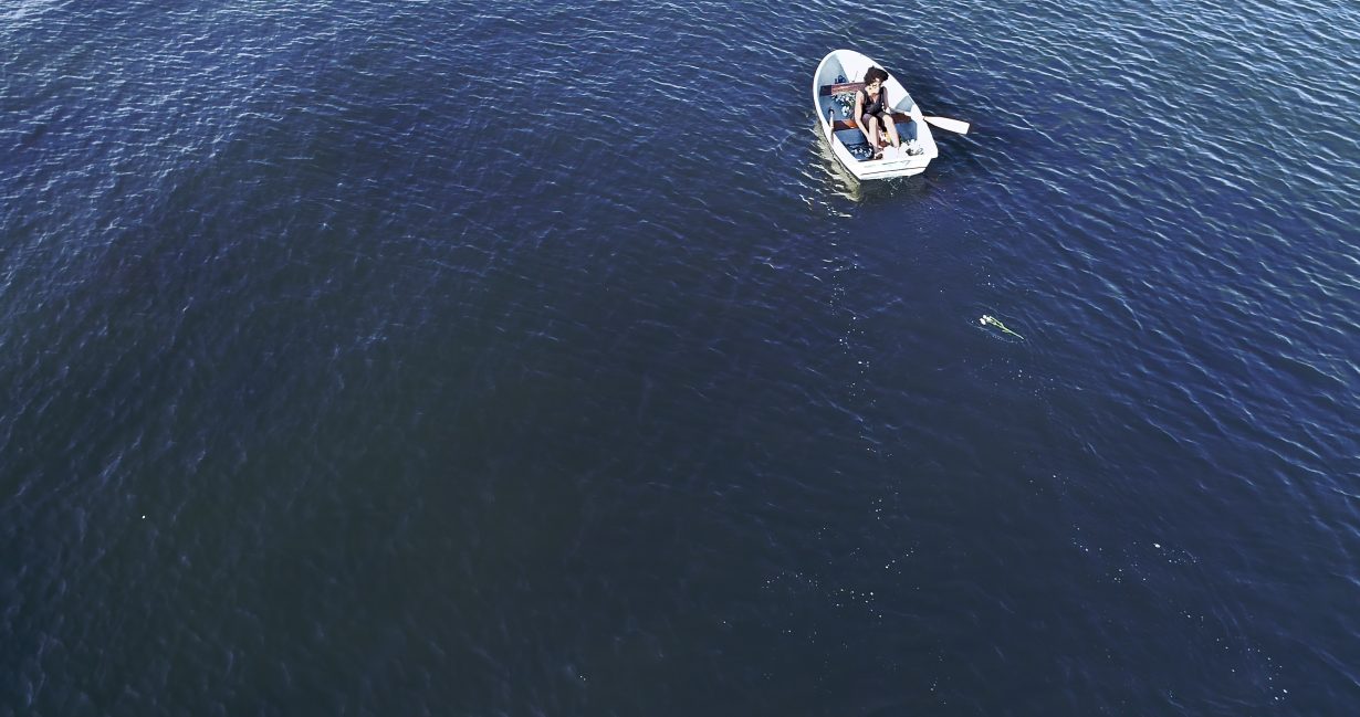 A small rowing boat on an empty body of water