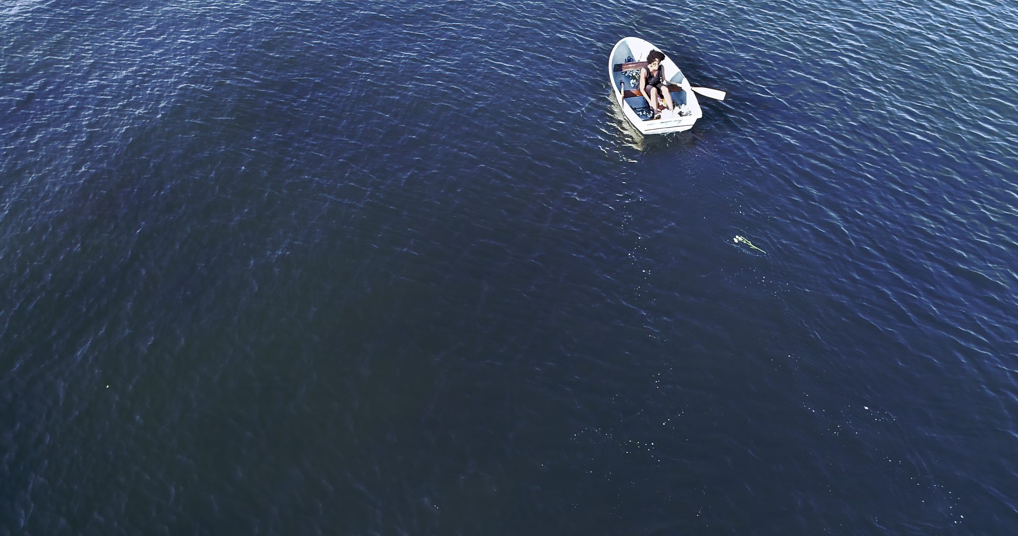 A small rowing boat on an empty body of water