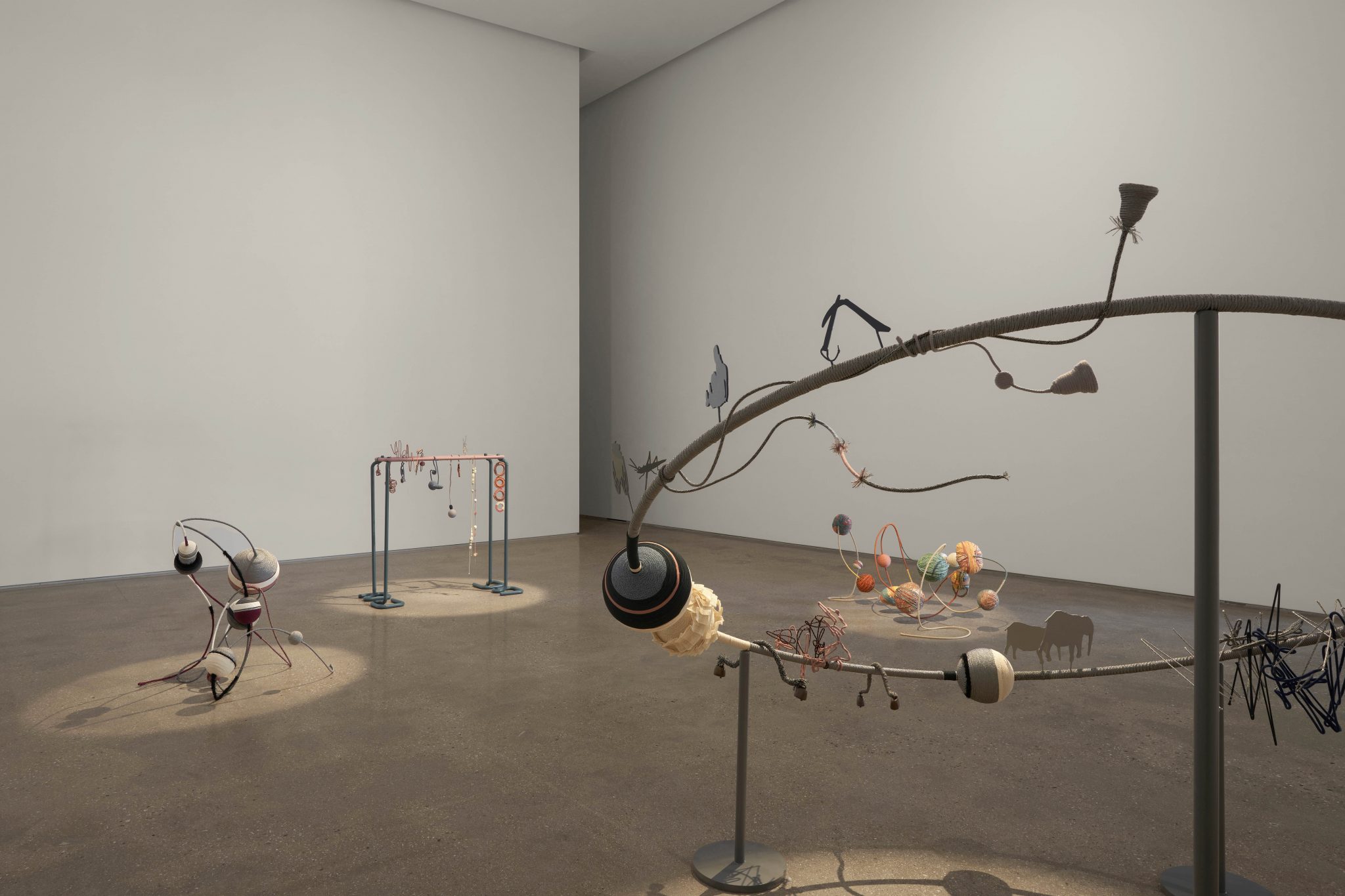 A sculpture in a white walled gallery