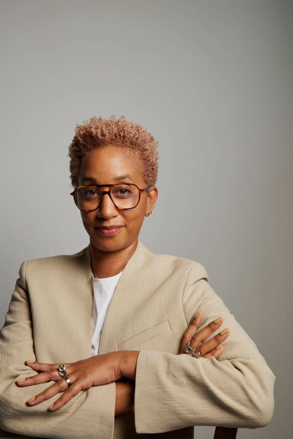 Photo of Melanie Keen in cream suit jacket with arms folded