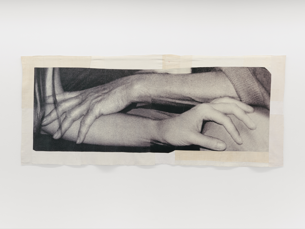 A photograph showing a closeup of folded arms