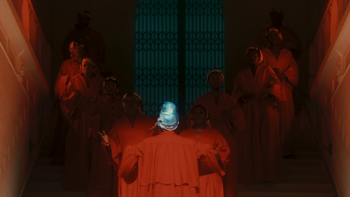 A choir basked in red light