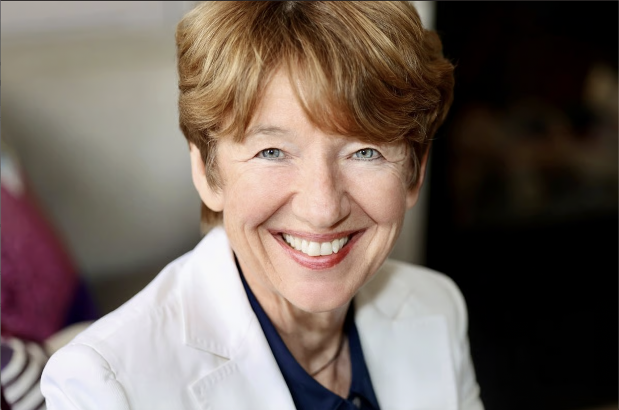 Portrait of Dawn Airey smiling in a cream jacket